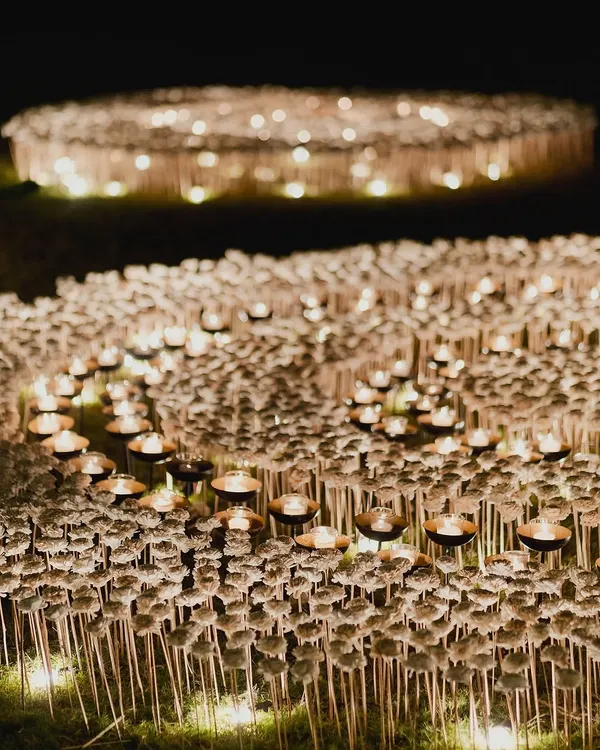 A closer view of our ethereal candle and flower field installation. Each of the thousands of blooms was placed by hand to create a gentle, undulating landscape of light and texture, designed to be a truly immersive art piece.