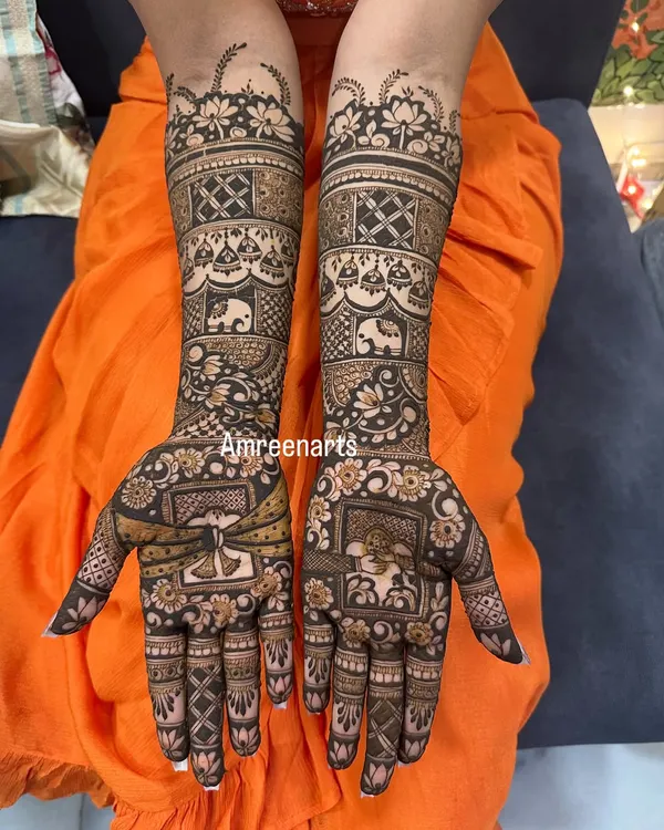 A classic bridal design featuring bands of traditional motifs, including elephants, paisleys, and a doli scene, creating a rich story on the arms.
