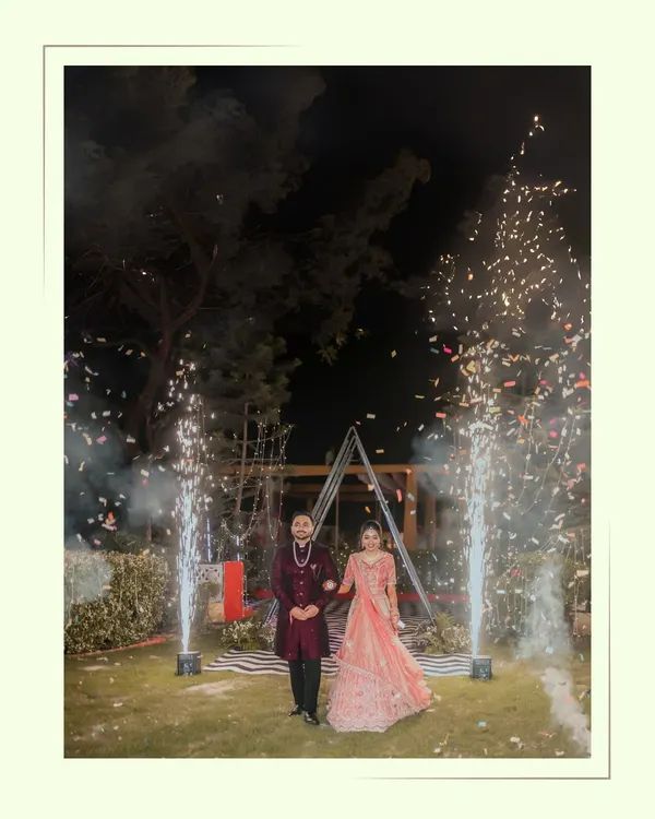 A magical entrance for Alankrit and Parul, walking hand-in-hand through a shower of cold pyrotechnics. We capture the grandeur and excitement of your key moments.