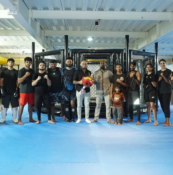 The whole team with "King James," the voice of our fighting championship. Our community extends beyond just our fighters to include everyone who supports our mission.