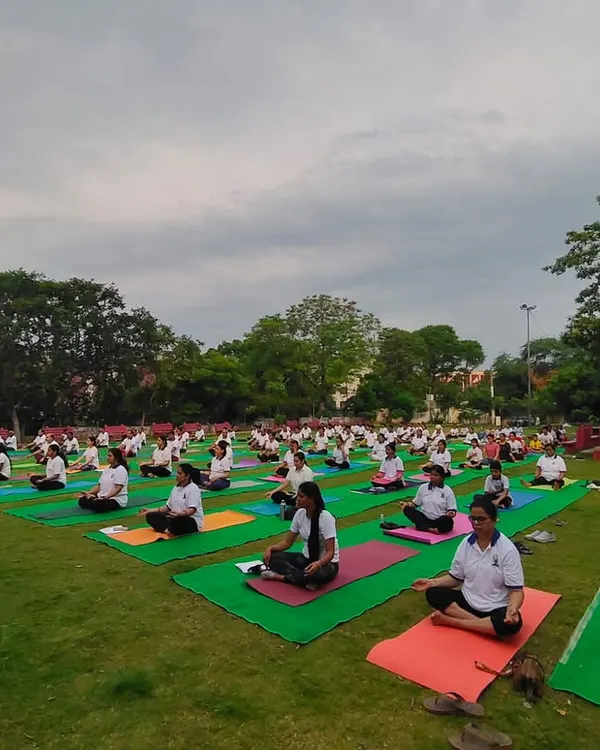 A wide shot of our community practicing meditation together outdoors. This was taken during our International Yoga Day celebration, reflecting our vision of creating one family of love and happiness.