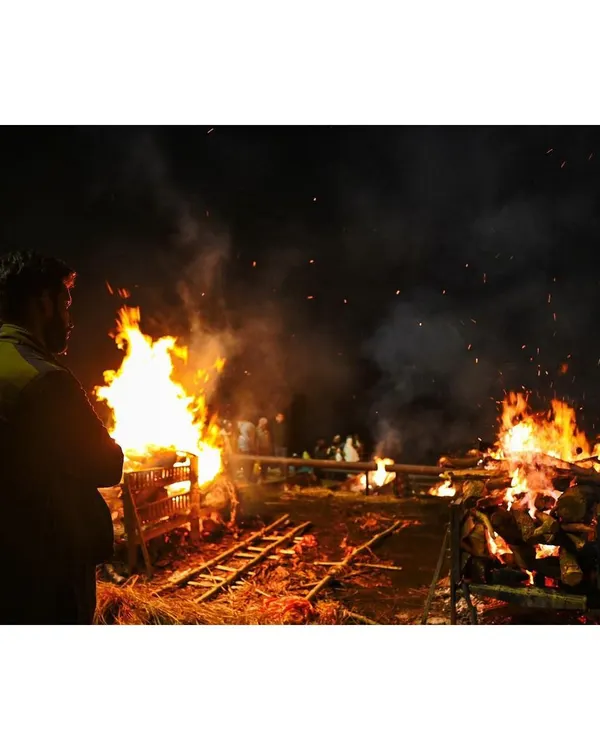 A man stands before the funeral pyres at Manikarnika Ghat. I wanted to capture this quiet moment of observation amidst the constant flames, showing the human connection to the powerful rituals of life and death in Varanasi.