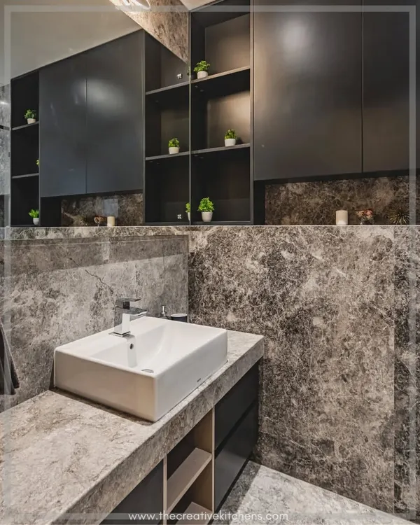 This monochromatic bathroom is all about opulence, using a dark marble-look tile to create a lavish feel. Our custom vanity and storage units in a dark finish provide ample storage while maintaining a minimalist, high-end look.