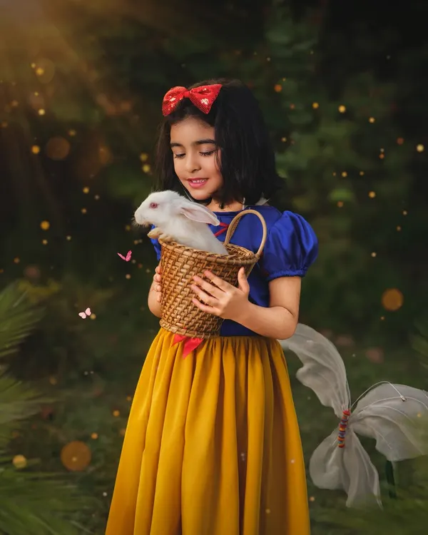 Our little Snow White gently holds a real bunny in an enchanted forest setting. These fantasy sessions are meticulously crafted to create a truly magical, storybook experience for your child.