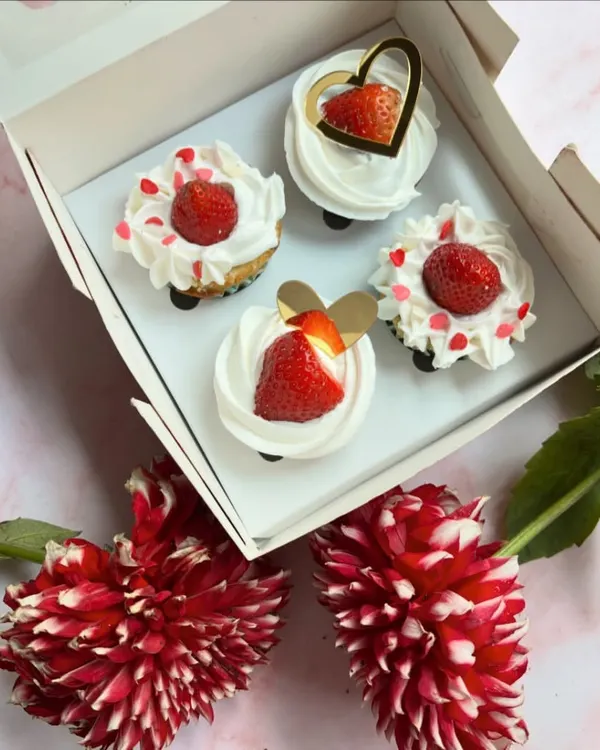 Spreading the love with these Valentine's Day special cupcakes. Topped with fresh strawberries and cream, they are the perfect sweet treat for your special someone.