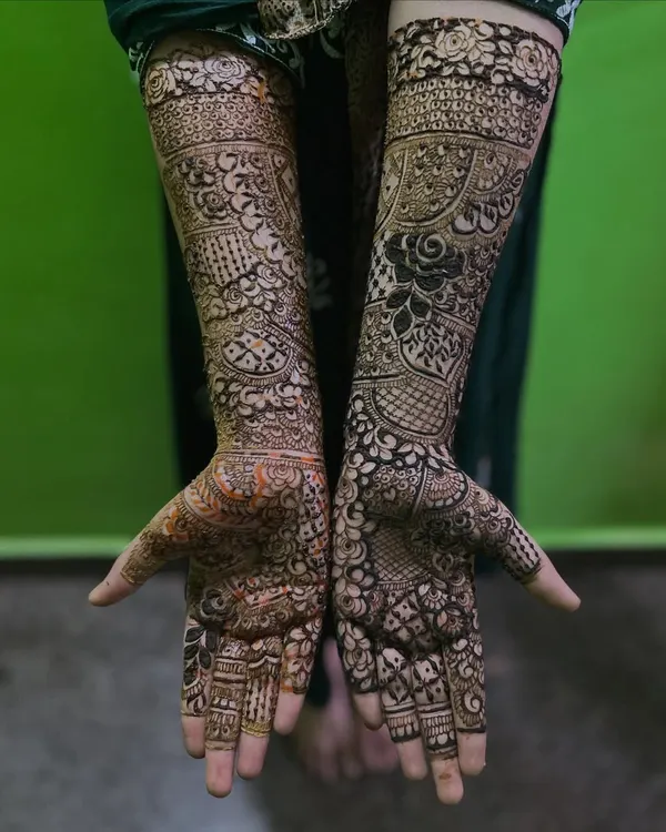 This is my signature full bridal mehendi, extending from fingertips to elbow. I love creating two unique yet complementary designs for each hand, filled with incredibly fine lines, checks, and floral patterns for a truly breathtaking result.
