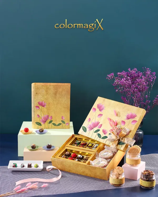 Our golden lotus print book box is a work of art. It opens to reveal a delightful assortment of chocolates and desserts in jars, making for a magical unboxing experience.