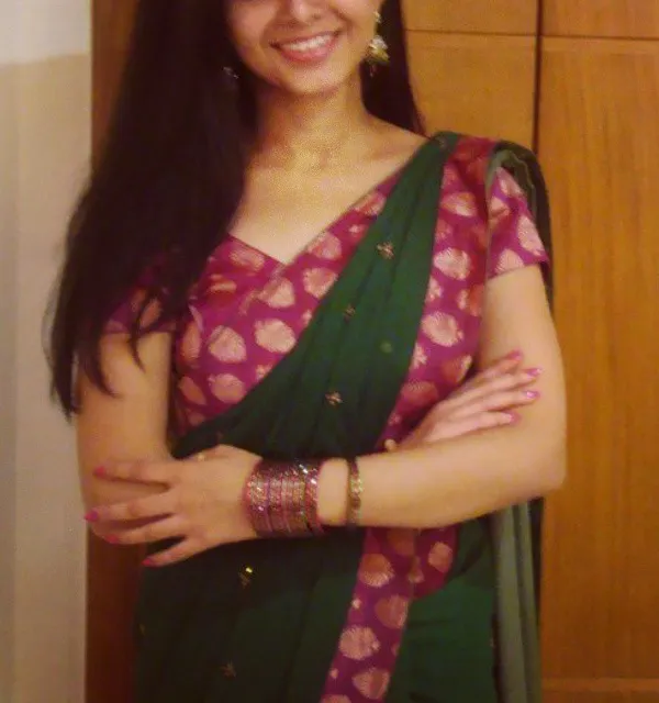 A happy client wearing a custom look for a family function. I designed a rich pink brocade blouse to complement her classic green saree, adding a pop of color and traditional elegance.