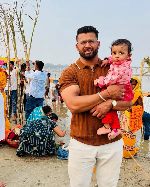 Holding my child during Chhath Puja at the Sangam. My family and my faith are the sources of my deepest strength and teach me the power of devotion.