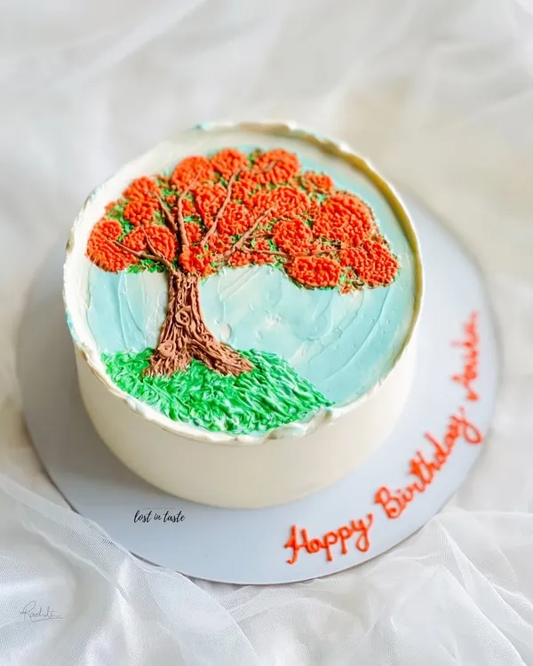 This cake is a tribute to the beautiful Gulmohar tree. The design is hand-piped with colored buttercream to create a miniature painting you can eat.