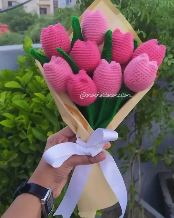 A beautiful, full bouquet of nine handmade pink crochet tulips, wrapped in elegant paper with a white ribbon. This everlasting arrangement is one of our most popular gifts for birthdays and anniversaries.