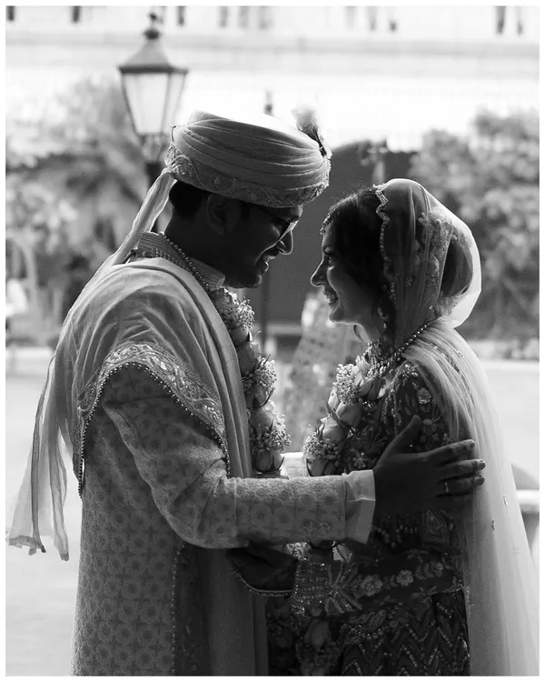 A classic black and white shot from a wedding day. The image freezes a quiet, intimate moment between the couple, their expressions telling a story of love and happiness. This is the kind of timeless memory I strive to capture.