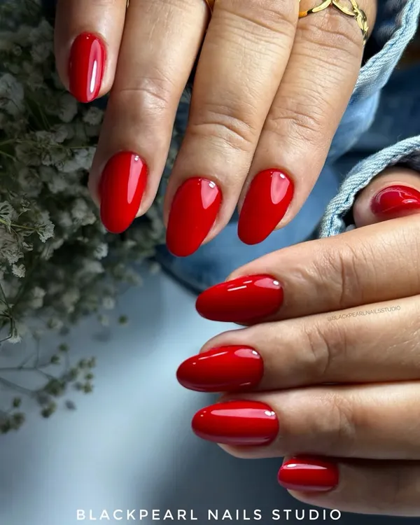 A classic, bold red manicure is always a power move. This set features a vibrant red gel polish on perfectly shaped almond nails for a look that is confident and timeless.