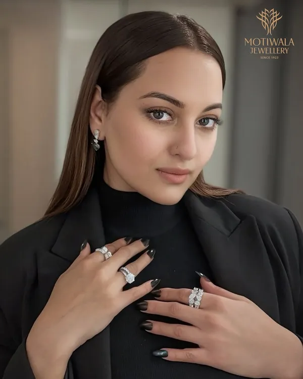 We present the stunning Sonakshi Sinha, the epitome of grace, adorned in a suite of our signature diamond creations. This look features a magnificent multi-diamond ring, complemented by a classic eternity band and elegant drop earrings, each piece reflecting our commitment to flawless craftsmanship.