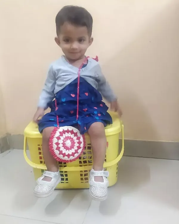 Here is my little one modeling the 'Merry' bag I made for her. It's the perfect size for a child to carry their small treasures.