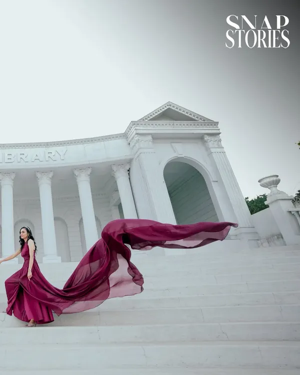 I create dramatic, magazine-worthy portraits using stunning architecture and flowing gowns. This shot at a location inspired by the Asiatic Library in Mumbai showcases how we can make your pre-wedding photos truly epic.