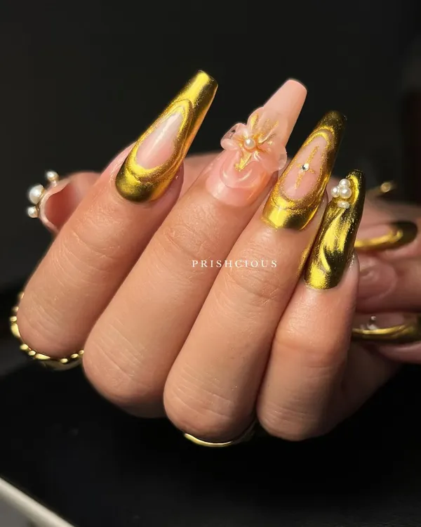 A side view of the stunning 3D gold chrome and flower nail art. You can really see the dimension of the clear floral charms and the liquid gold effect of the chrome.
