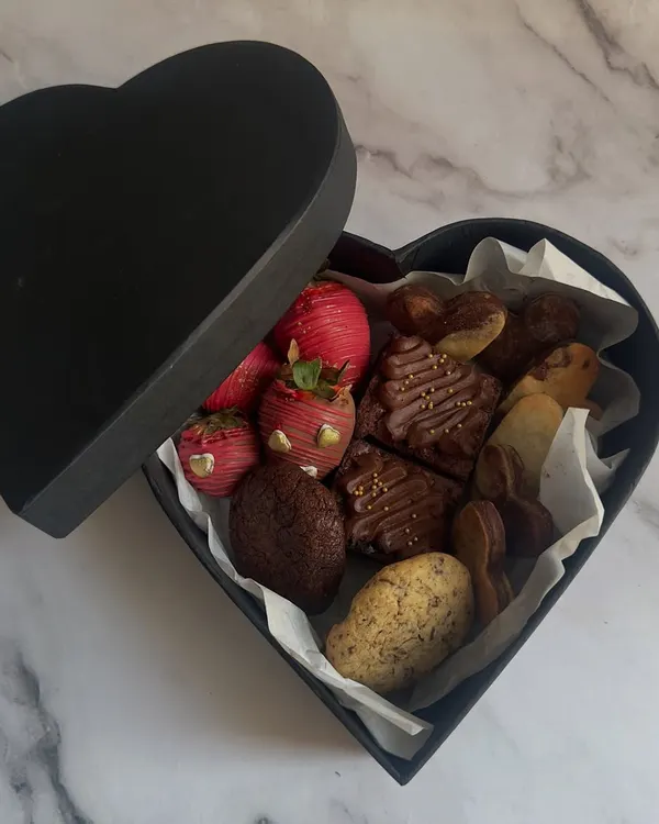 My Valentine's heart-shaped box is filled with an assortment of romantic treats. Inside, you'll find chocolate-dipped strawberries, fudgy brownies, and a selection of my gourmet cookies.