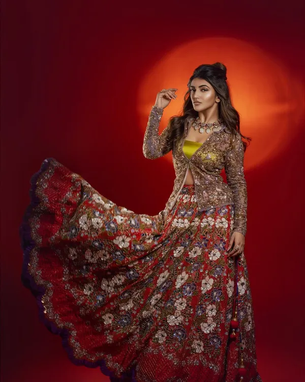 Styling actress Sreeleela in a vibrant, floral-embroidered lehenga with a matching jacket. The look was for a magazine feature, and I aimed for a playful yet regal aesthetic against a bold red background.
