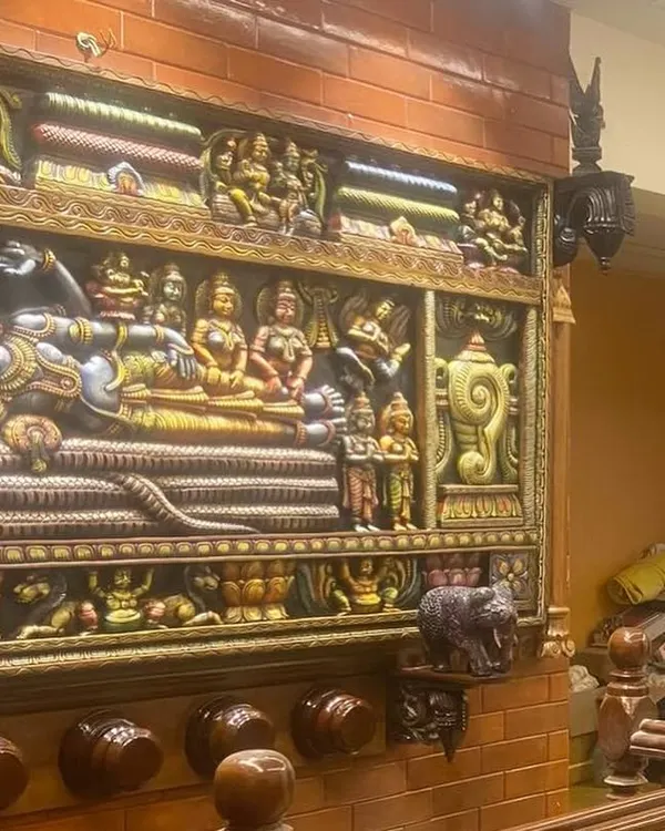 A customer-shared image of our Sri Ranganathar panel installed as a magnificent centerpiece. The integrated lighting highlights the depth and vibrant colors of the carving, creating a sacred focal point in their home.