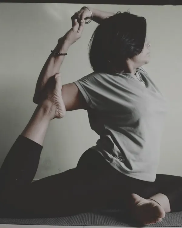 Practicing Rajakapotasana (King Pigeon Pose). This advanced asana is a deep hip and heart opener that improves spinal mobility, reduces stress, and stimulates digestion.