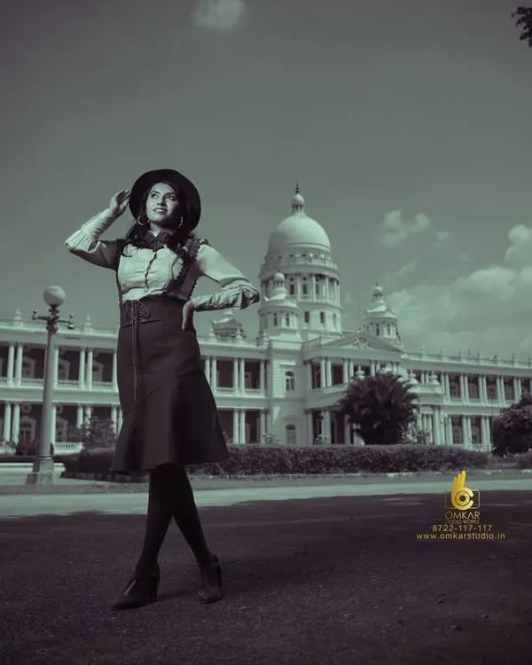 A wide-angle shot from our vintage fashion series, placing the model against the grand backdrop of a Mysore landmark. The desaturated, black and white treatment gives this image a timeless, old-world feel, perfect for an editorial story.