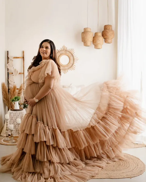 This gorgeous mom-to-be looks like a goddess in this tiered, ruffled gown. We shot this in my studio's boho-themed setup, which adds a warm, earthy feel to these glamorous maternity portraits.