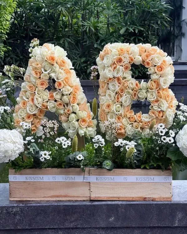 Sending big love with these custom floral initials. Crafted from hundreds of peach and cream roses and set in a rustic wooden box, this is a beautiful and personal way to celebrate a wedding, engagement, or anniversary.