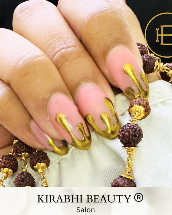 This unique gold drip nail art gives the illusion of molten metal flowing down the nails. It's a 3D effect that I create using a special gel for a truly artistic finish.