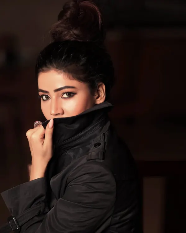 A mysterious and moody portrait with the collar of a trench coat pulled up. This style of headshot is great for creating a specific character or dramatic feel.