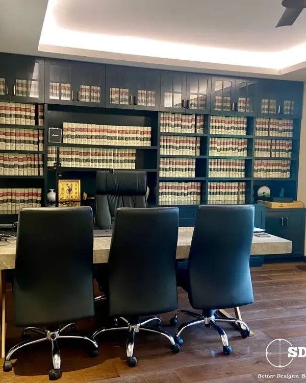 A classic lawyer's office we designed, featuring a floor-to-ceiling bookshelf for legal volumes. The large desk and ergonomic chairs create a commanding and professional workspace.