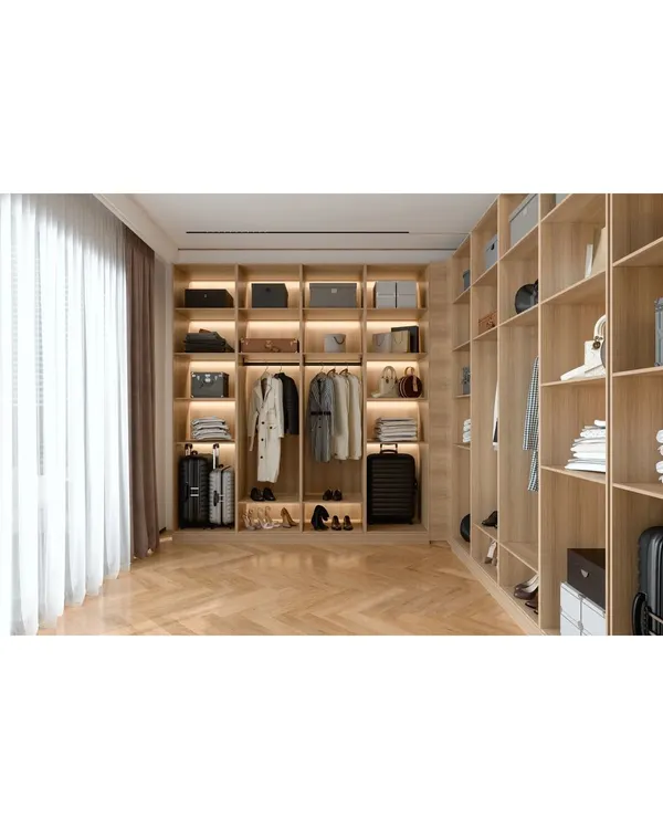 A spacious walk-in wardrobe with custom-built wooden shelving. We designed this space with integrated lighting to showcase the collection and make organization easy and beautiful.