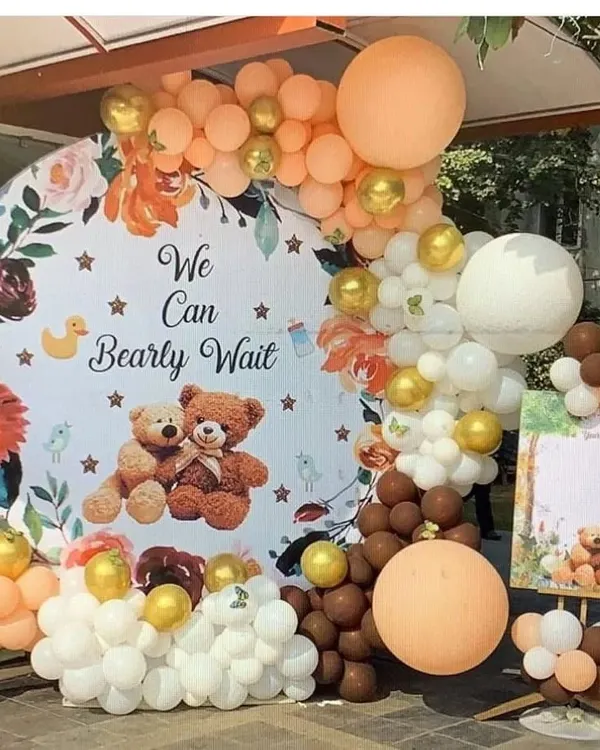 I create beautiful themed backdrops for baby showers, like this popular "We Can Bearly Wait" setup. This includes a custom printed backdrop, a full balloon arch in earthy tones of brown, white, and peach, and a matching welcome board. It's perfect for photos.