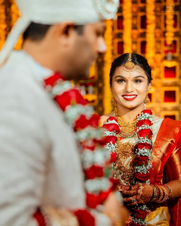 A candid moment during a South Indian wedding ceremony. The bride's joyful expression as she looks at her groom is the kind of genuine emotion I strive to capture, framed by their beautiful floral garlands.