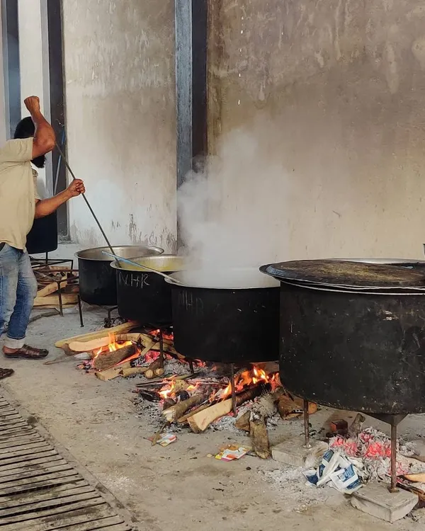 Here is one of my cooks stirring a large degh over a wood fire. This is the authentic, hands-on method I use for all my large-scale cooking.