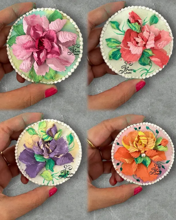 A beautiful collection of four 4-inch circular fridge magnets, each featuring a unique, colorful sculpted flower. These are perfect for adding a pop of color to your kitchen.