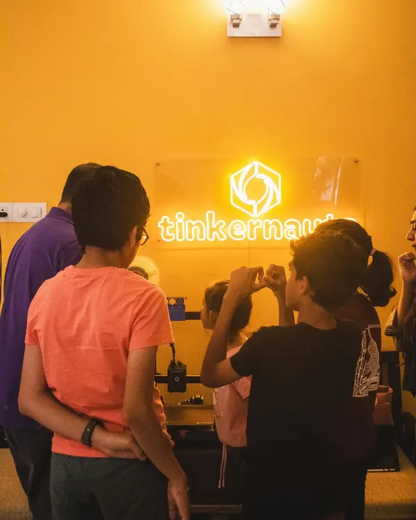 A typical scene from one of our workshops, with students gathered around a 3D printer, watching their digital designs become physical objects. We create an environment of shared discovery and excitement.