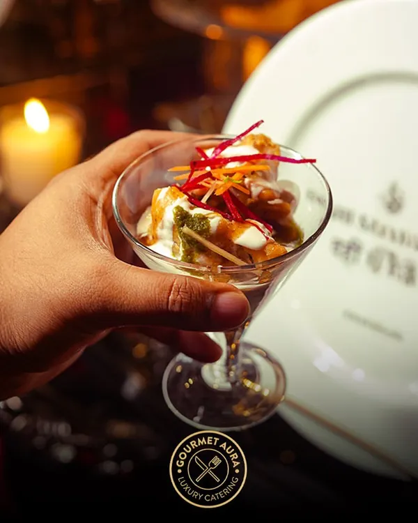 An elegant presentation of chaat in a martini glass, showcasing how we elevate classic Indian street food into a gourmet experience suitable for the most luxurious events.