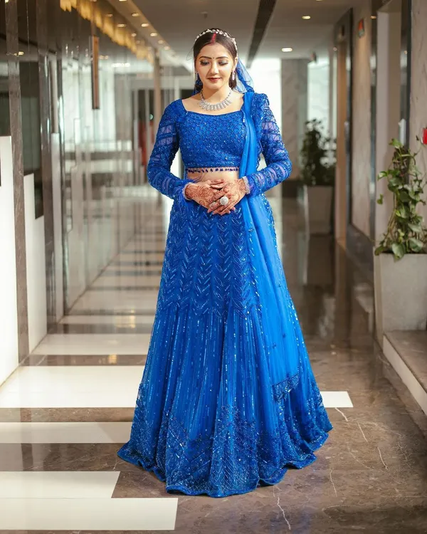 The perfect shot of a happy client in her custom royal blue lehenga. I designed this piece to be a showstopper, and her confidence and joy say it all.