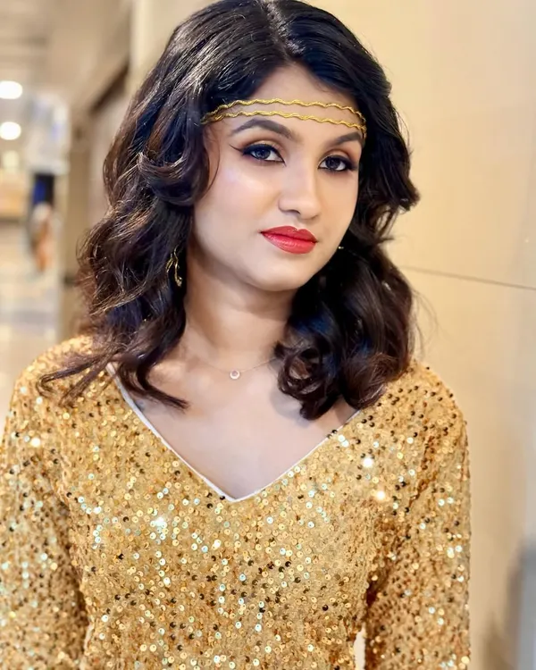 A full glamour look for a model shoot, featuring shimmering gold eyeshadow, sharp winged liner, and a classic red lip. The look is bold, confident, and perfect for a party or event.