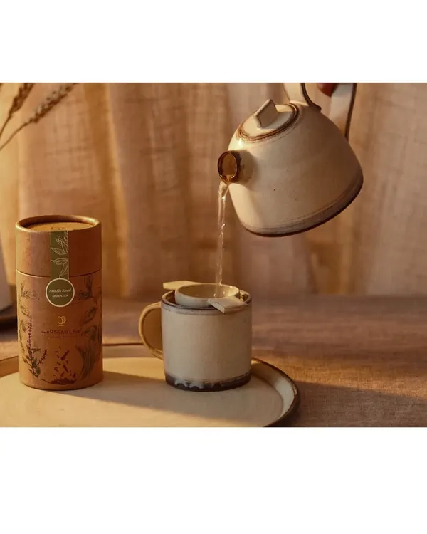 An action shot capturing the moment of pouring hot water to brew tea. This image tells a story of preparation and mindfulness, highlighting both the product and the experience.