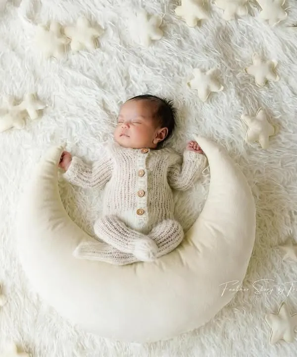 This is the magic we love to create. A peaceful newborn portrait, nestled on a crescent moon, surrounded by stars. This classic, dreamy setup is perfect for capturing the wonder of your new arrival in our cozy studio.