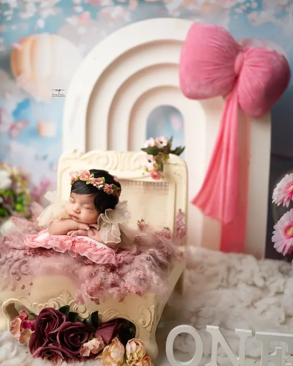 A tiny princess dreaming in a world of pink and lace. I love creating these serene, fairytale setups for my newborn sessions, ensuring every detail is as perfect and peaceful as your little one.