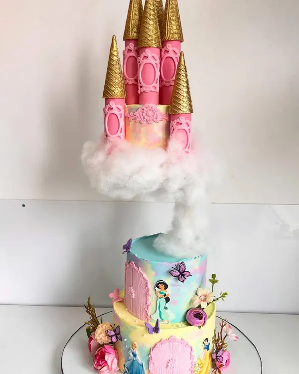 This gravity-defying princess castle cake is a fairytale brought to life. We engineered this piece with a floating top tier resting on a cloud of cotton candy, complete with intricate, hand-sculpted details and a soft pastel watercolor finish, making it a truly magical centerpiece.