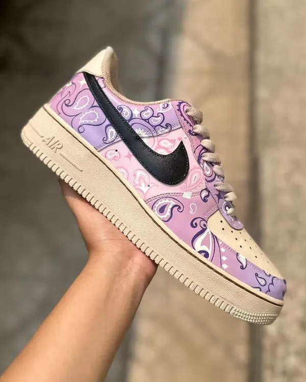 These are my coffee-dipped paisley Nike Dunks. I first dye the entire shoe in coffee to get that vintage, creamy base color, and then hand-paint the delicate paisley pattern in shades of lavender. The result is a soft, beautiful, and totally unique pair.
