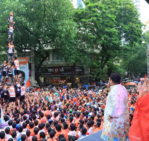 A breathtaking view from the stage as a Govinda team forms a multi-tiered human pyramid. We ensure our stage and viewing areas are designed to capture the full spectacle of such traditional feats.