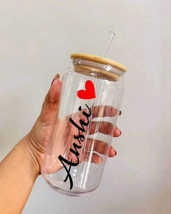 A personalized glass tumbler with a bamboo lid and straw, customized with the name 'Anshi' in a beautiful script font. These are great as individual gifts or as part of a larger hamper.
