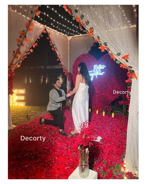A truly dreamy proposal moment inside a candlelit canopy, set on a bed of red rose petals. I design these intimate and romantic settings to make your 'yes' moment absolutely perfect.