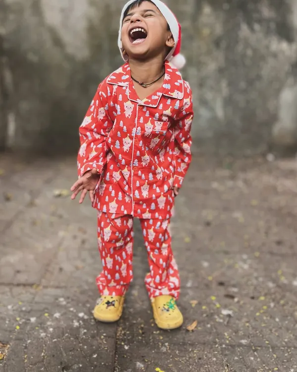 The purest Christmas laugh! This little one is feeling the festive joy in our super-soft red Santa print pajama set. It's perfect for Christmas morning and cozy holiday nights.
