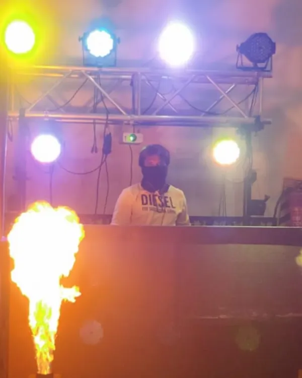 This is the kind of energy I bring to every event. A shot of me at the console, surrounded by dynamic lighting and a blast of fire from the pyrotechnics, setting the stage for an epic wedding reception party.